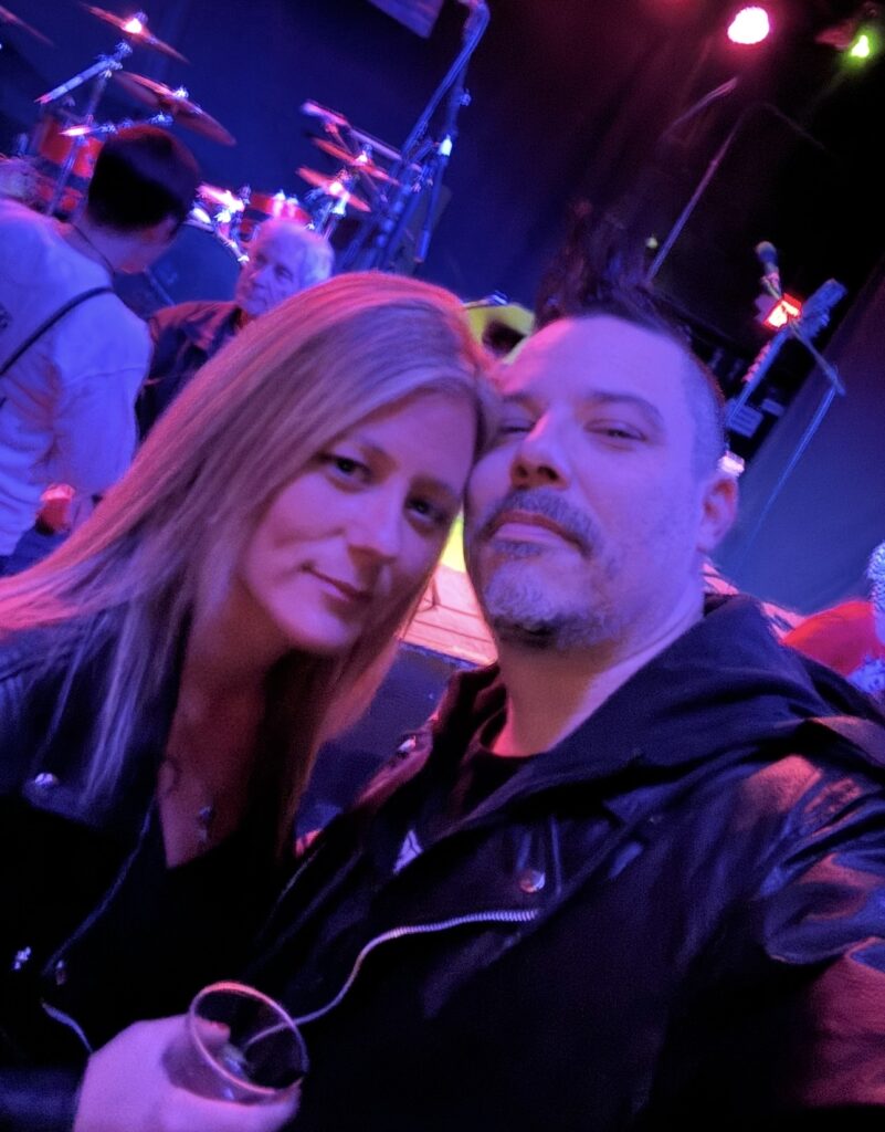 Double Down Mac and Nikki at a live punk rock concert.