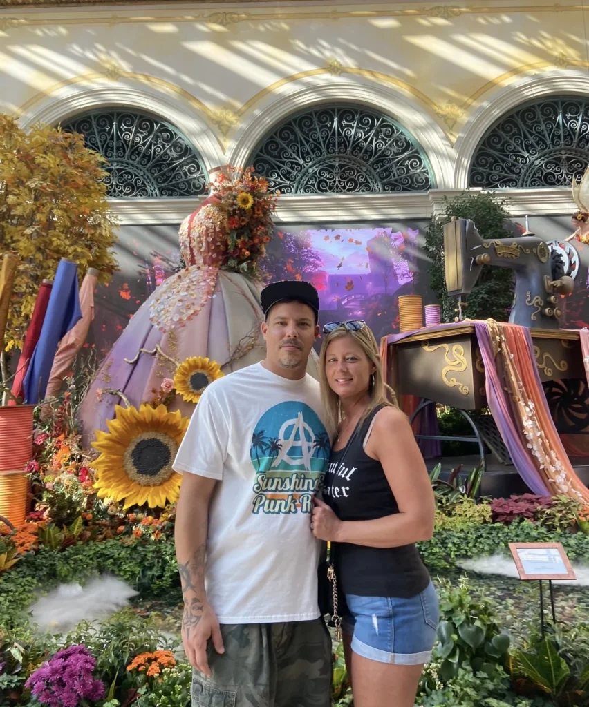 Double Down Mac and Nikki posing in front of the Bellagio Conservatory & Botanical Gardens fall display in Las Vegas.