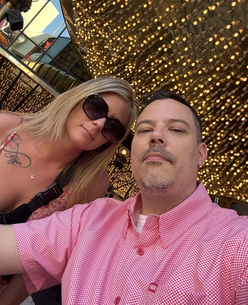 Double Down Mac and Nikki posing outside Plaza Hotel & Casino on Fremont Street in downtown Las Vegas.