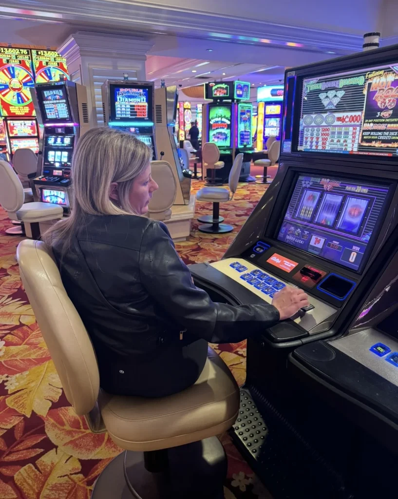 Nikki playing a slot machine on the casino floor during a Las Vegas trip.