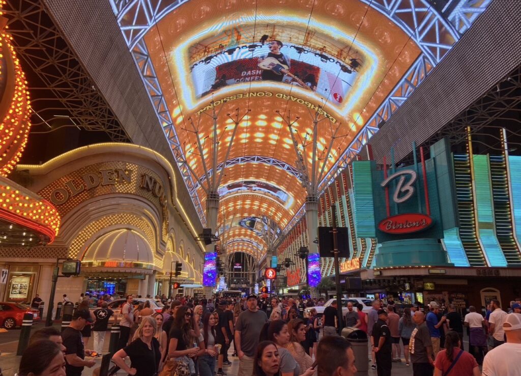 Crowds walking beneath the Fremont Street Experience canopy in downtown Las Vegas at night