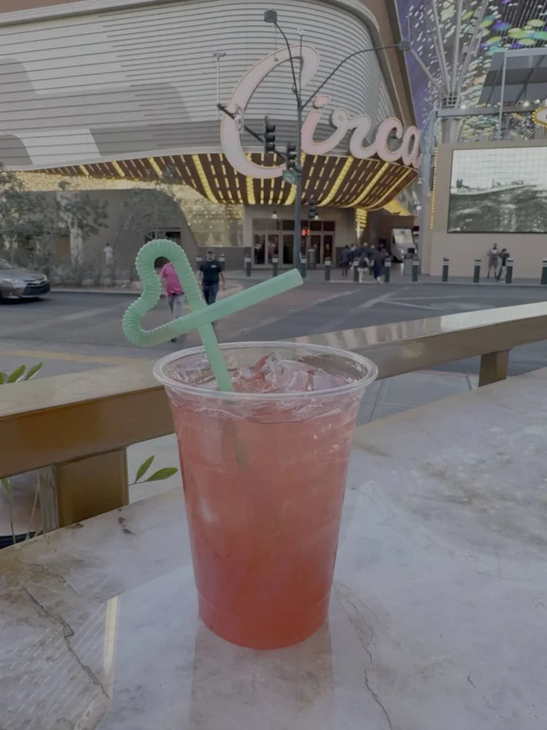 Pink cocktail at the Plaza Carousel Bar with Circa in the background