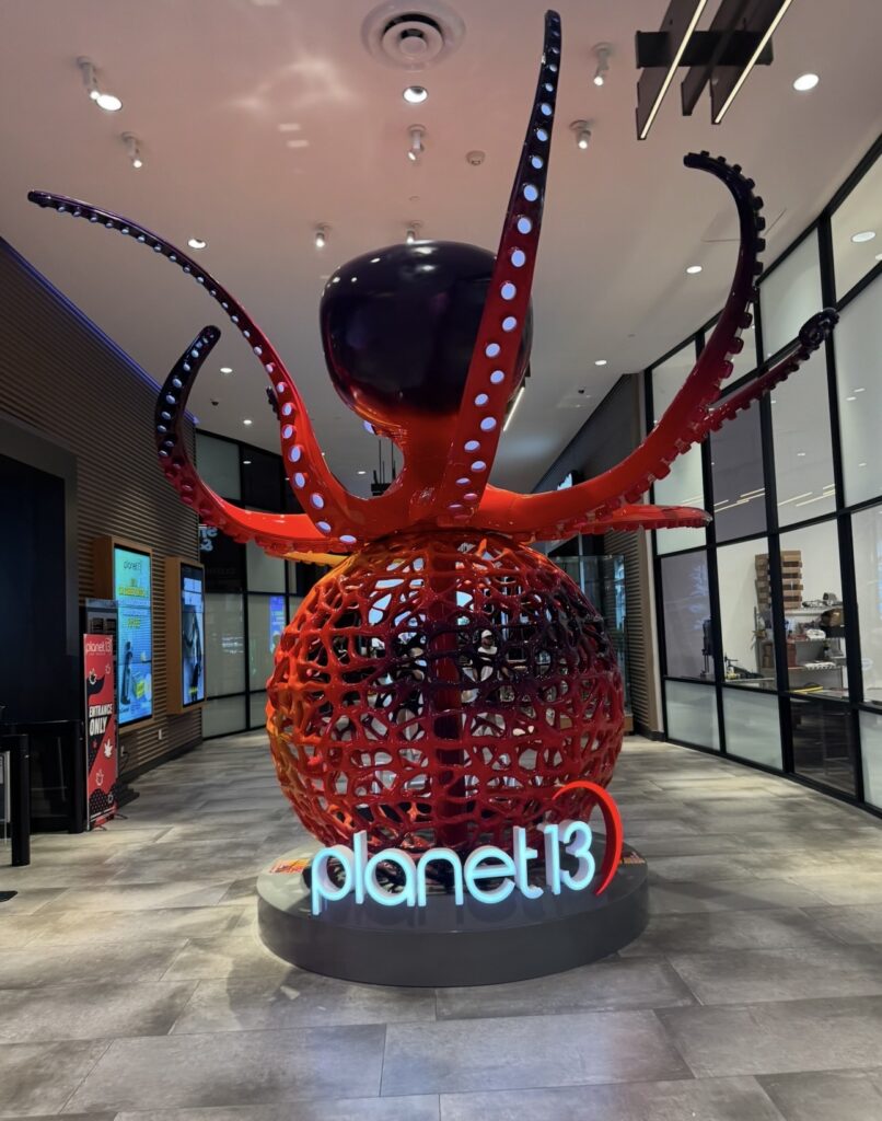 Large red octopus sculpture inside Planet 13 Las Vegas