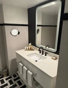 Modern bathroom vanity and mirror in a Versailles Tower room at Paris Las Vegas