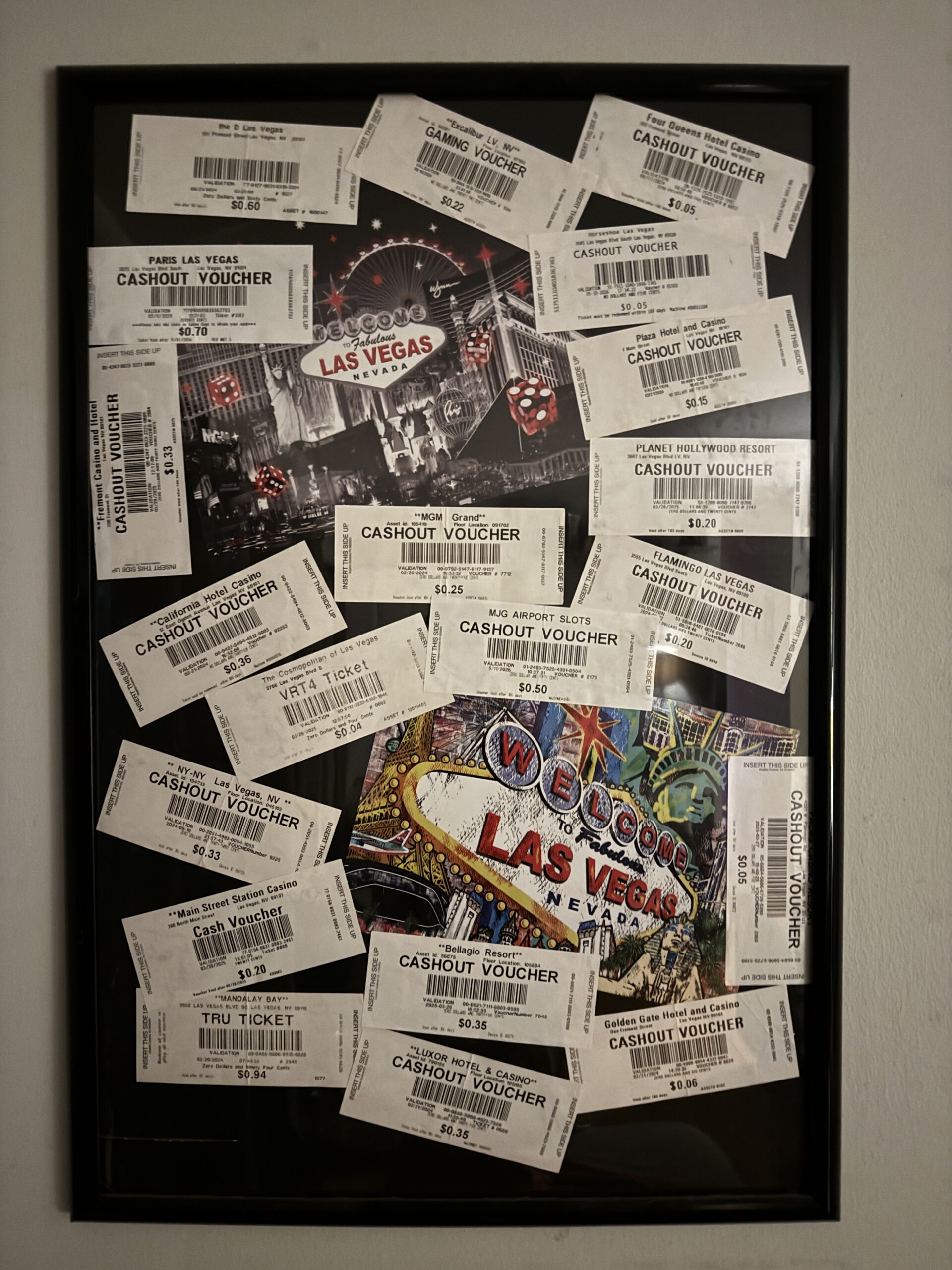 Framed collection of 19 Las Vegas casino cash-out tickets from different casinos, arranged around Welcome to Las Vegas artwork.